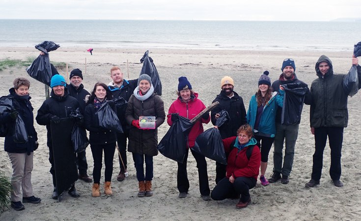 Thomson staff collecting rubbish on a beach clean © Thomson Environmental Consultants