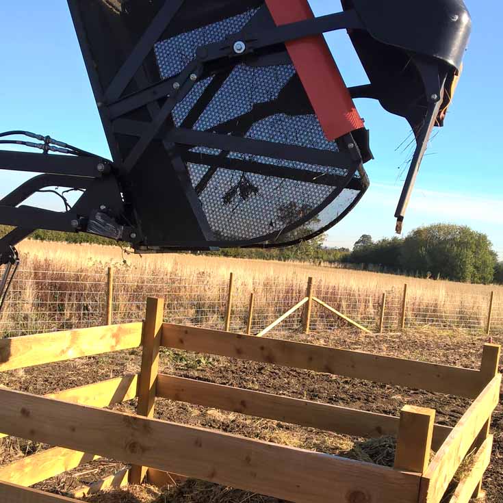 A Kubota G23 Ride On Hi-Tip Mower and trailer, tipping grass cuttings into a box to create an egg laying site © Thomsonec