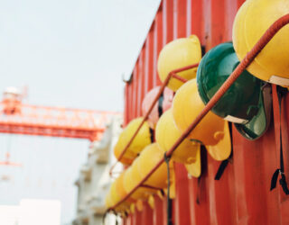 Yellow and green hard hats on a rack © rawpixel.com